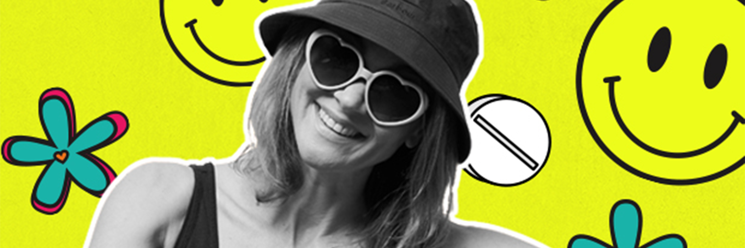 A bright yellow patterned background with smiley faces and flowers. Layered in front is a black and white image of a young woman smiling, wearing heart-shaped sunglasses and a bucket hat