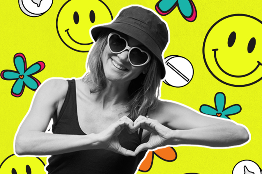 A bright yellow patterned background with smiley faces and flowers. Layered in front is a black and white image of a young woman smiling, making a heart shape with her hands in front of her, wearing heart-shaped sunglasses and a bucket hat