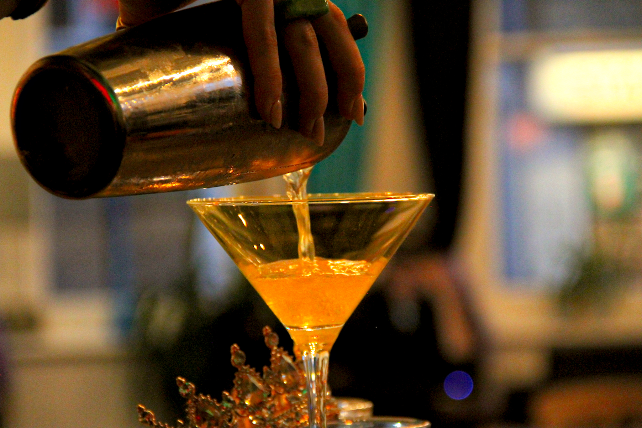 A photograph of The Crown cocktail being poured into a glass as part of the cocktail recipe blog.