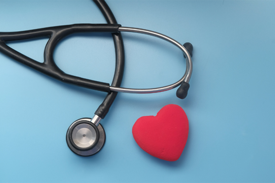 A stethoscope and a red heart against a baby blue backdrop