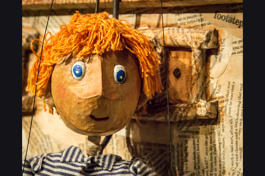 Jack the puppet has ginger hair and blue eyes
