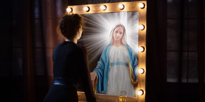 The back of a woman with short hair's head as she looks into a mirror, a glass of pinot sits on the table
